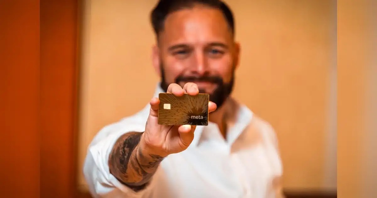 Joshua Denne holding a digital asset card