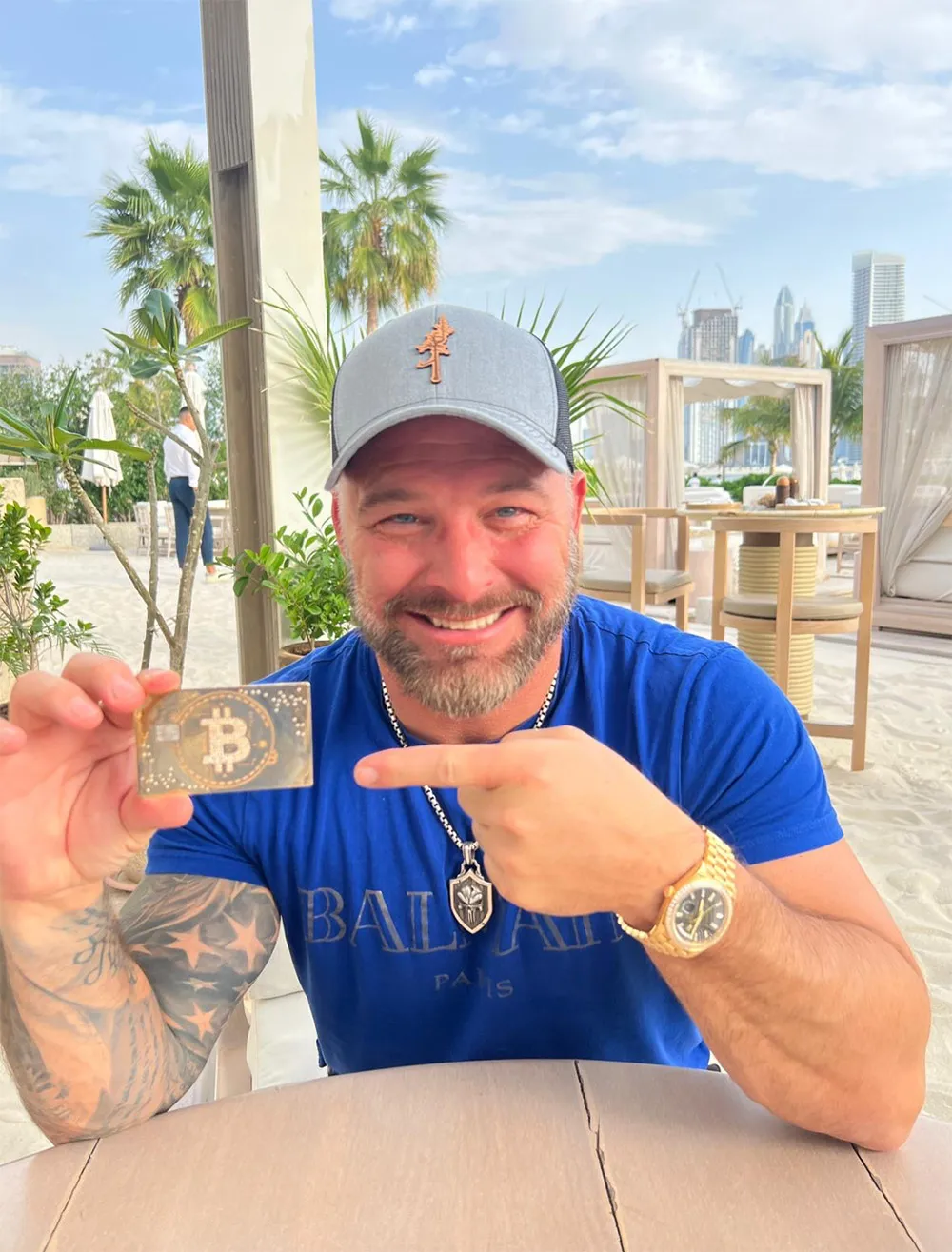 Joshua Denne holding a digital asset card