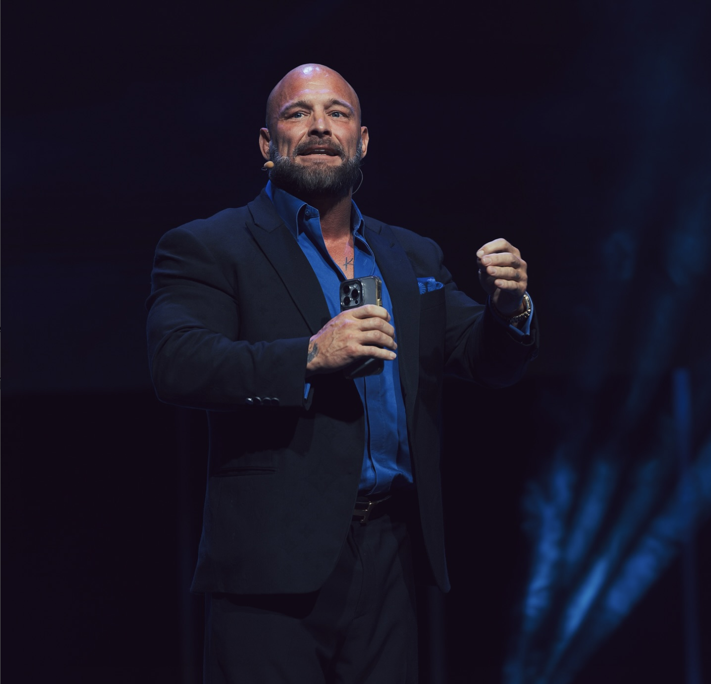 Joshua Denne speaking on stage